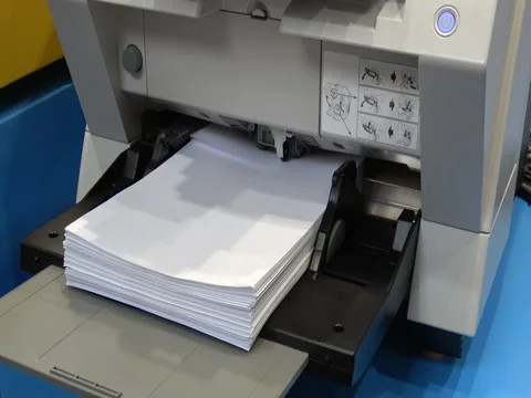 A bundle of paper is inserted in the printer, printing process Stock Footage 76871102