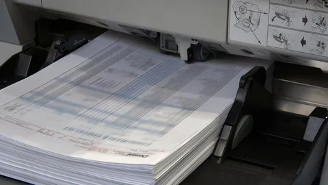 A bundle of paper is inserted in the printer, printing process Stock Footage 76873296
