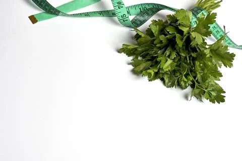 A bundle of parsley with a measuring tape Stock Photos