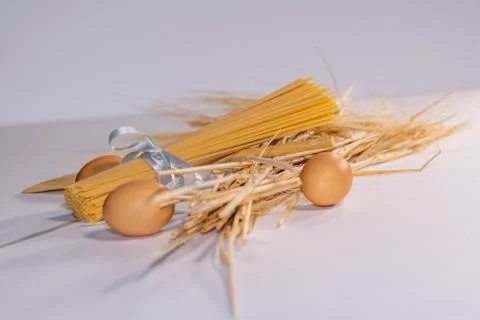 Bundle of pasta with brown eggs and wheat Stock Photos