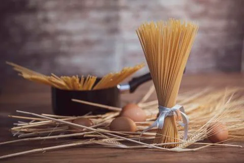 Bundle of pasta with wheat, eggs and a saucepan Stock Photos