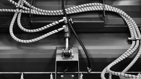 Bundle of pipes connected to industrial hydraulic pneumatic machine, tech ind Stock Photos