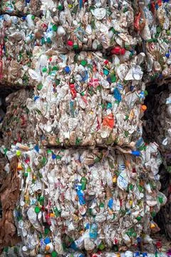 Bundle of pressed plastic bottles prepared for a garbage recycling on waste Stock Photos