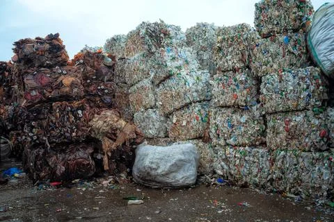 Bundle of pressed plastic bottles prepared for a garbage recycling on waste Stock Photos