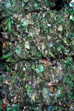 Bundle of pressed plastic bottles prepared for a garbage recycling on waste Stockfoto's