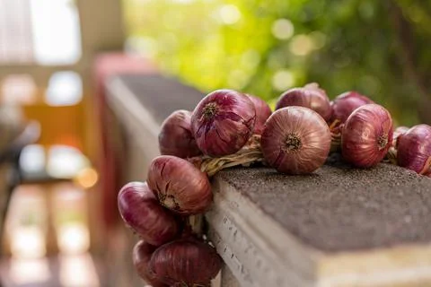 Bundle of red onion on the balcony Stock Photos