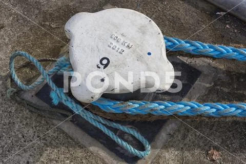 Bundle of rope on the ship mooring bollard Stock Photos