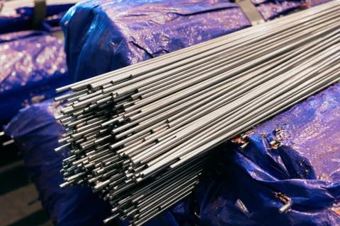 A bundle of stainless steel bars. Large industrial warehouse metal Stock Photos