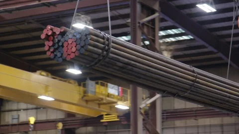 Bundle of Steel being Transported on Crane in Factory near ceiling rafters Stock Footage 125498797