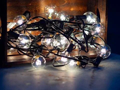 Bundle of string lights in wooden box 스톡 사진