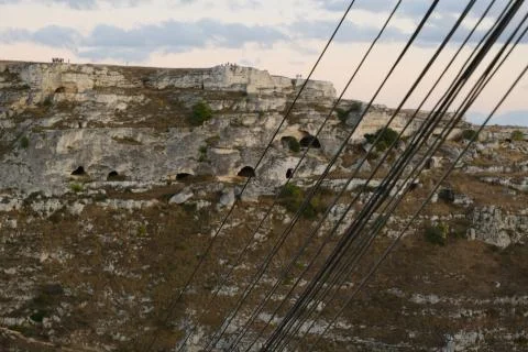 Bundle of telephone cables with the background of ancient caves used as house Stock Photos