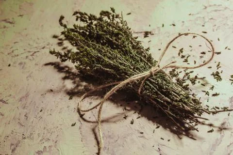 Bundle of thyme sprigs on a textural background Stock Photos