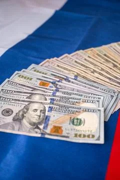 A Bundle of US Dollars on the Russian Flag Stock Photos