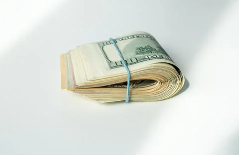 A bundle of US dollars is wrapped in a rubber band Stock Photos