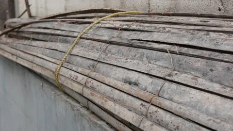 Bundle of Weathered Bamboo Poles Tied with Rope Stock Footage 336762703