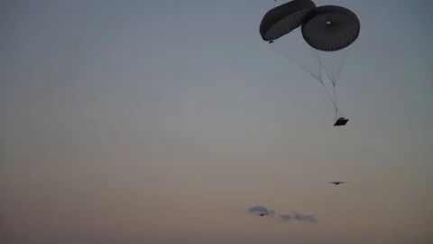 Bundles of food being dropped from Lockheed Martin C-130J Super Hercules - 2018 Stock Footage 87339146