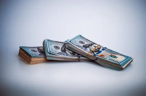 Bundles of packaged dollars on a white background. Stock Photos