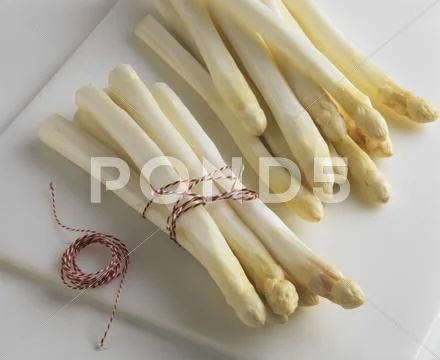 Bundles of peeled asparagus ready for cooking Stock Photos