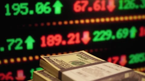 Bundles of US dollars against the background of trading quotes. Stock Footage 260472503