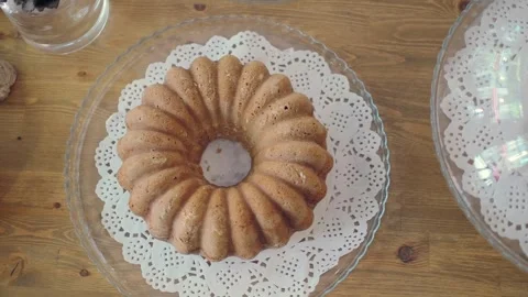 Bundt cake on a table with lace doily Stock Footage 339258226