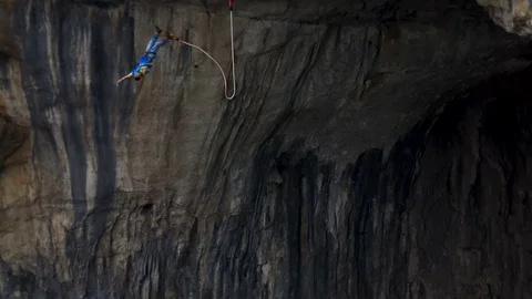 Bungee jump as extreme and fun sport Prohodna Cave 150 feet Stock Footage 79634402