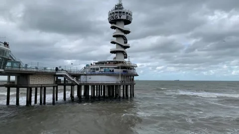 Bungy tower at Scheveningen beach. Motion of sea waves. The Hague, Netherlands Stock Footage 287579692