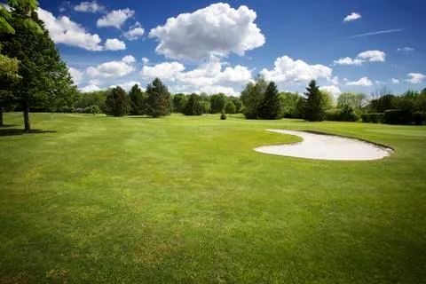 Bunker on golf course and cloudy sky Stock Photos