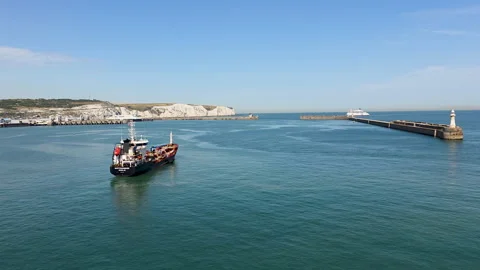 Bunkering service vessel approaching Dover Western Docks with White Cliffs and Stock Footage 346798968