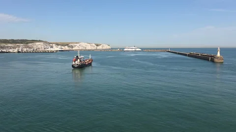Bunkering vessel entering Dover Western Docks with White Cliffs and harbour Stock Footage 346798898