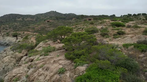 Bunkers on top of the hill drone view Punta Falconera Stock Footage 294204043