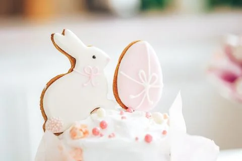 Bunny biscuits and eggs on Easter cake in front of the kitchen Stock Photos