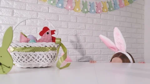 Bunny ears are showing at the table in an easter prepared kitchen Stock Footage 124010689