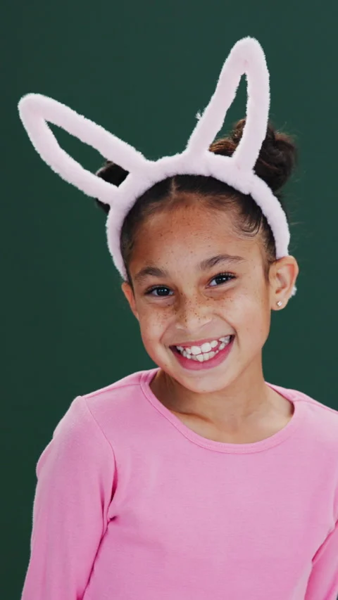 Bunny ears, easter and face of little girl on studio background for celebration Stock Footage 340453765