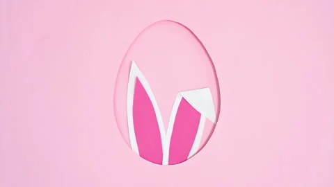 Bunny ears moving in Easter egg shape frame on pink background. Stop motion Stock-Footage 171359876