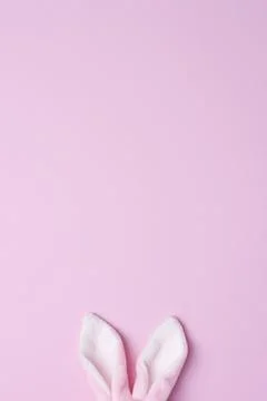 Bunny ears on pink background. Flat lay, copy space beautiful Stock Photos
