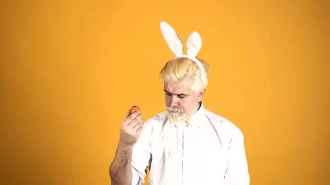 Bunny man with egg. Easter bearded guy rabbit. Man with rabbit ears. Isolated. Stock Footage 146569993