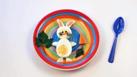 Bunny rabbit made of boiled eggs on multicolored plate Stock Footage 172563451