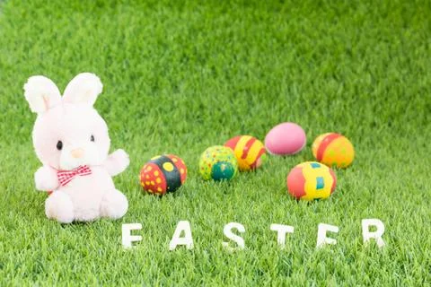 Bunny toy and Easter eggs with text Stock Photos