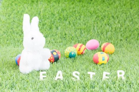 Bunny toy and Easter eggs with text Stock Photos