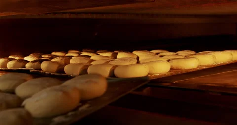 Buns baking in the oven at a bakery, close-up in 4K. Stock Footage 221566170