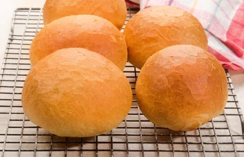 Buns on a floured cooling rack Stock Photos