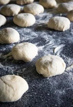 Buns sprinkled with flour on the table Stock Photos