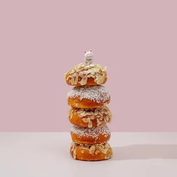 Buns stacked one on one in a stack, there is a toy cat on top 스톡 사진