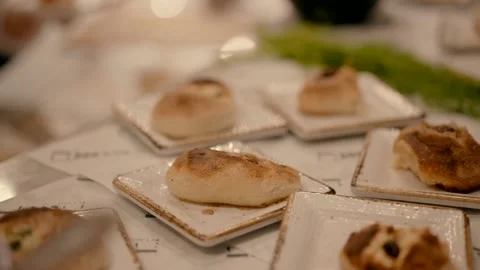 Buns stuffed with meat are arranged in square plates on the table Stock Footage 226604733
