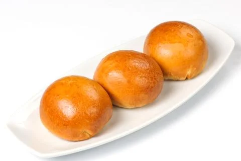Buns on a white plate Stock Photos