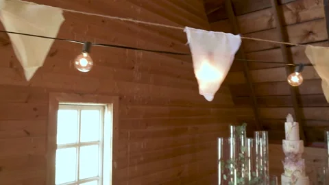 Bunting and string light decorations above wedding cake Vídeo Stock 220456232