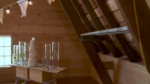 Bunting, string lights and wedding cake in barn Stock Footage 220456241