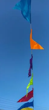 Buntings with colorful triangular flags against blue sky . Stock Photos