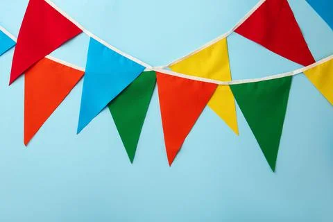 Buntings with colorful triangular flags on light blue background. Festive dec 스톡 사진