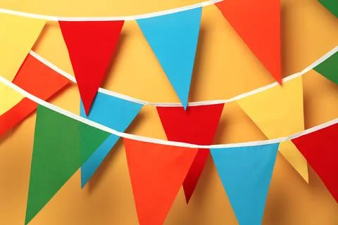 Buntings with colorful triangular flags on orange background Stock Photos